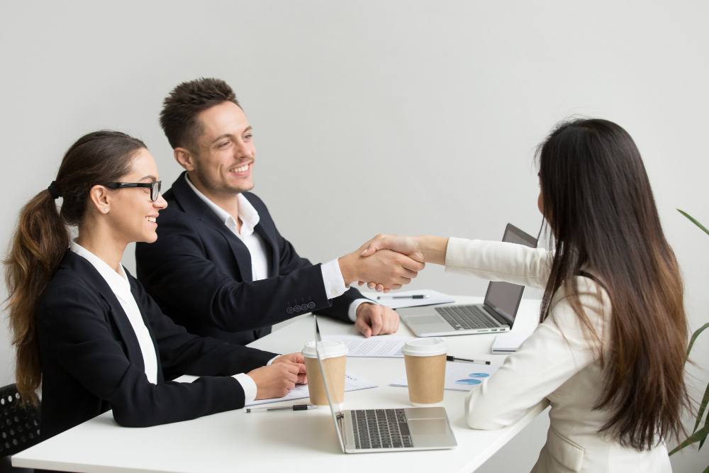 friendly-partners-handshaking-group-meeting-thanking-successful-teamwork.webp